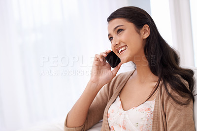 Buy stock photo Happy woman on sofa with phone call, relax and conversation with mobile connection in apartment. Indian girl sitting on couch with smile, talking on cellphone and communication for networking in home