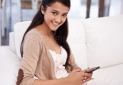 Buy stock photo Happy woman, portrait and phone typing on sofa for communication, social media or networking at home. Female person smile on mobile smartphone for online chatting, texting or research in living room