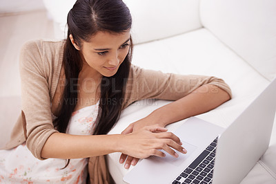 Buy stock photo Girl on sofa with laptop, search and relax with remote work, website and browse in living room. Woman on couch with computer for freelance job, internet research and reading email online in home.