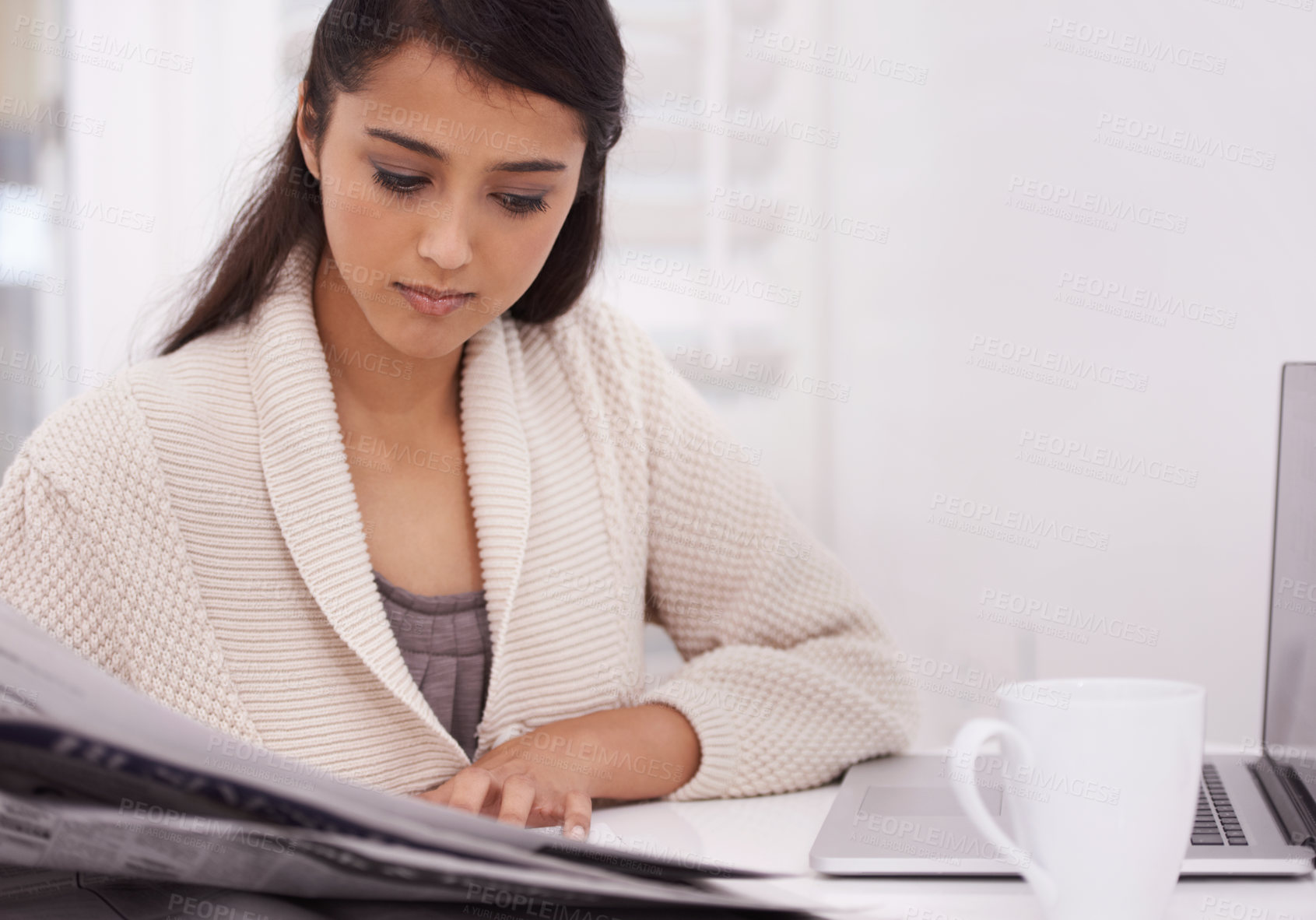 Buy stock photo Woman, morning newspaper and reading in home by laptop for remote work, economy or check stock market. Person, trader and newsletter for financial stats, information or thinking by computer in house