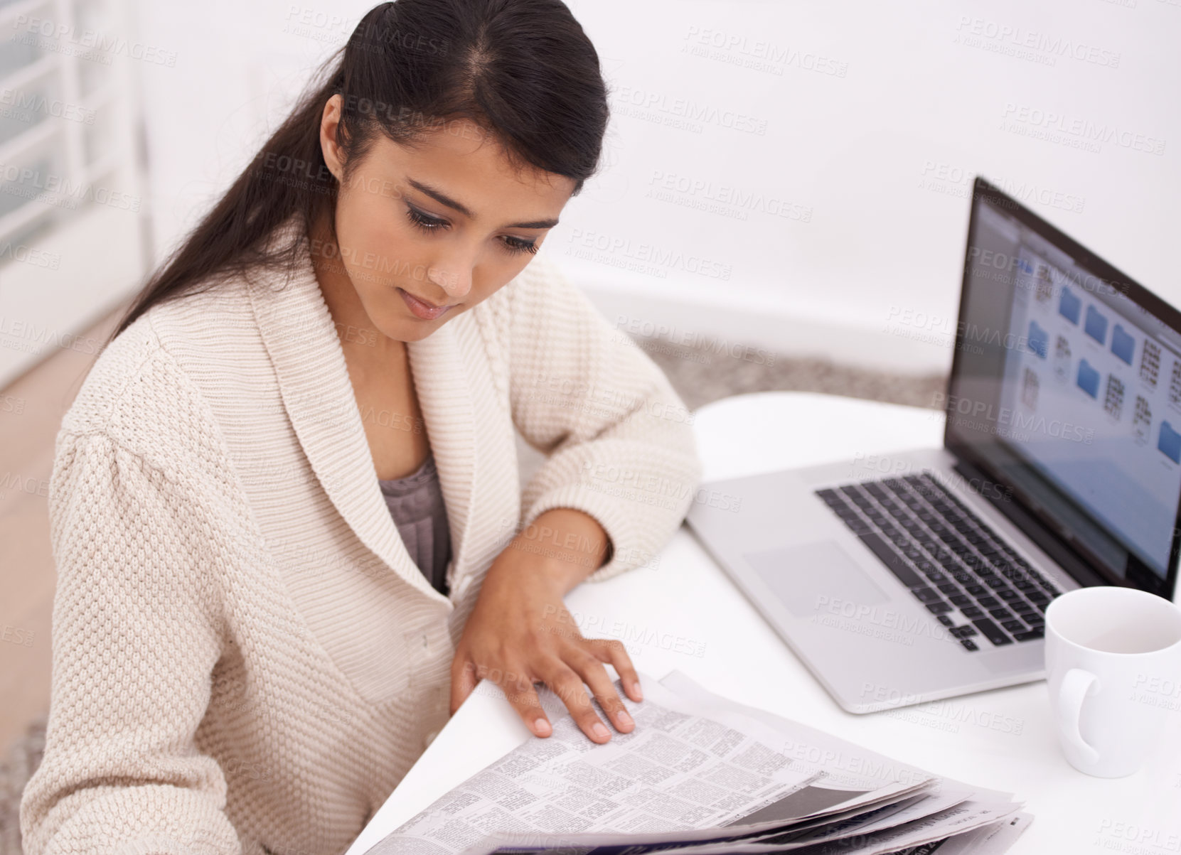 Buy stock photo Woman, morning newspaper and reading in house by laptop for remote work, economy or check stock market. Person, trader and newsletter for financial stats, information or thinking by computer in home