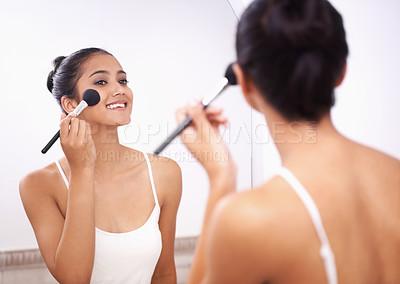 Buy stock photo Happy woman, face and makeup brush in mirror for beauty, cosmetics or grooming in bathroom at home. Female person smile and applying foundation, blush or contour for facial treatment in reflection