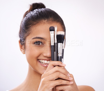 Buy stock photo Makeup, brushes and woman face with eyes cosmetics in studio for beauty and foundation on a white background. Young model, artist or person in portrait for skincare, eyeshadow or product for coverage