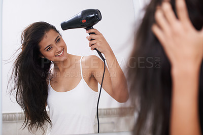 Buy stock photo Blow dry, home and woman with hair care, happy  and mirror with treatment, grooming and routine. Person, smile and girl with salon equipment, texture and volume with shine, glowing and wellness