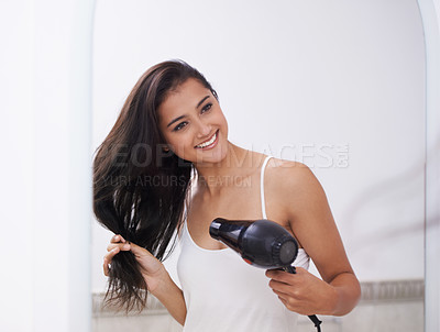 Buy stock photo Woman, mirror and blow dryer for haircare and transformation in bathroom, grooming and morning routine. Indian female person, happy and hairstyle or cosmetology, keratin treatment and appliance