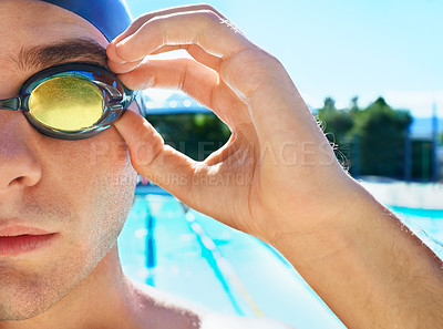Buy stock photo Cropped portrait of a handsome male swimmer getting ready to compete