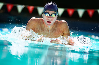 Buy stock photo Cropped view of a male swimmer in mid lap