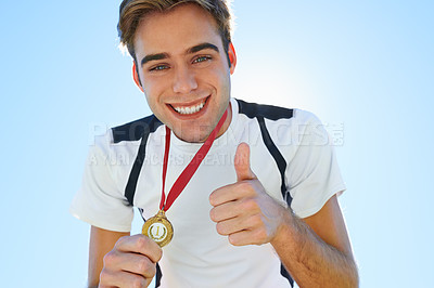 Buy stock photo Athlete, portrait and thumbs up with medal for sports achievement, success and yes in competition. Face of winner, runner or man with like, prize or good job hands, emoji and gold award on a blue sky