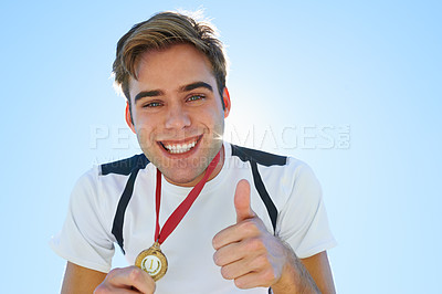 Buy stock photo Athlete, man and thumbs up with medal for sports achievement, success portrait and yes in competition. Face of winner or runner with like, smile or good job hands, emoji and gold award on a blue sky