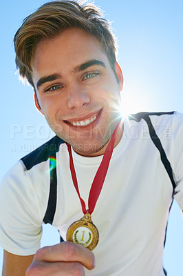 Buy stock photo Winner, man and sports medal for achievement, success and portrait in running competition. Happy face of a runner or athlete with red and gold prize, contest or marathon on a blue sky and lens flare