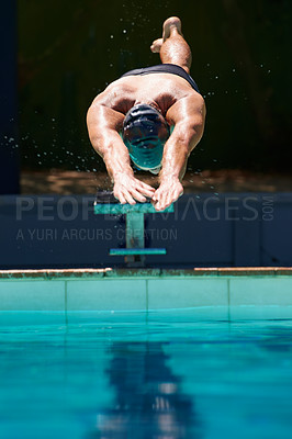 Buy stock photo A young man diving off a starting block