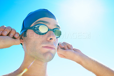 Buy stock photo Swimming, blue sky and face of sports man determined for exercise, outdoor workout or training routine. Swimwear, sunshine and person with cap, goggles and getting ready for  active cardio practice