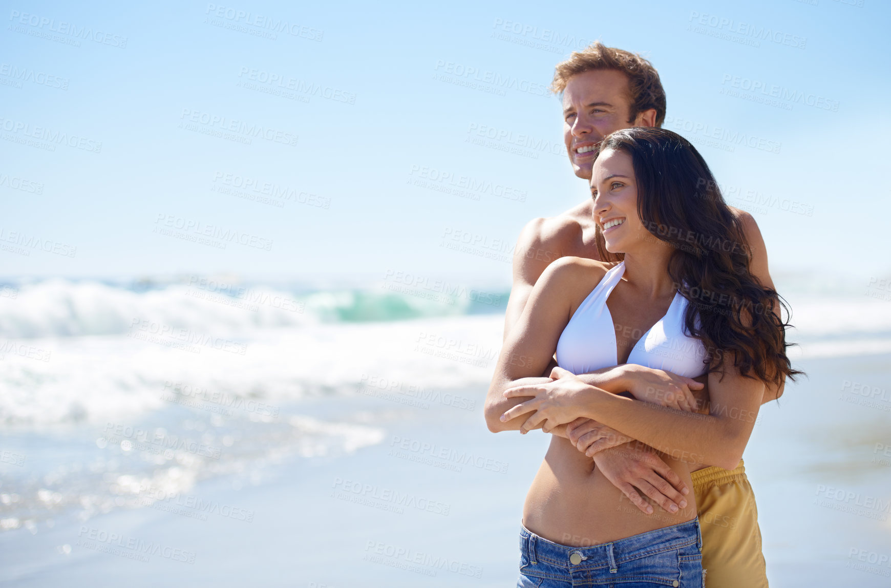 Buy stock photo Embrace, love and happy couple on beach for holiday adventure together on tropical island with blue sky. Smile, man and woman on ocean vacation with waves, hug and mockup on romantic travel in Hawaii
