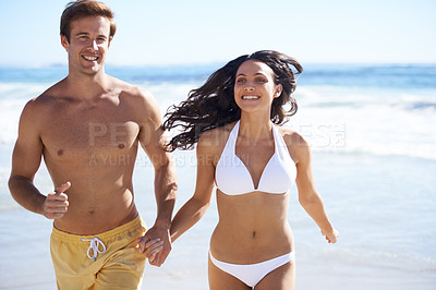 Buy stock photo Holding hands, run and happy couple on beach for holiday adventure together on tropical island with waves. Love, man and woman on fun ocean vacation with waves, romance and smile on travel in Hawaii.