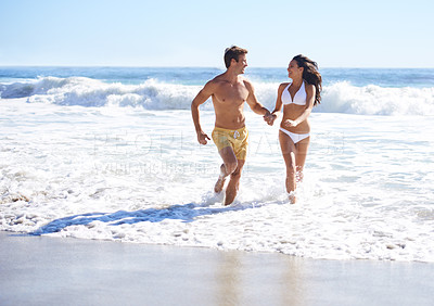 Buy stock photo Holding hands, waves and happy couple running on beach for holiday adventure together on tropical island with care. Love, man and woman on ocean vacation with fun, romance and smile on travel in Bali