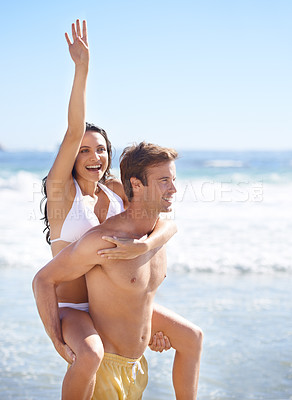 Buy stock photo Piggy back, waves and happy couple on beach for holiday adventure together on tropical island on blue sky. Love, man and excited woman on ocean vacation with fun, romance and smile on travel in Bali.