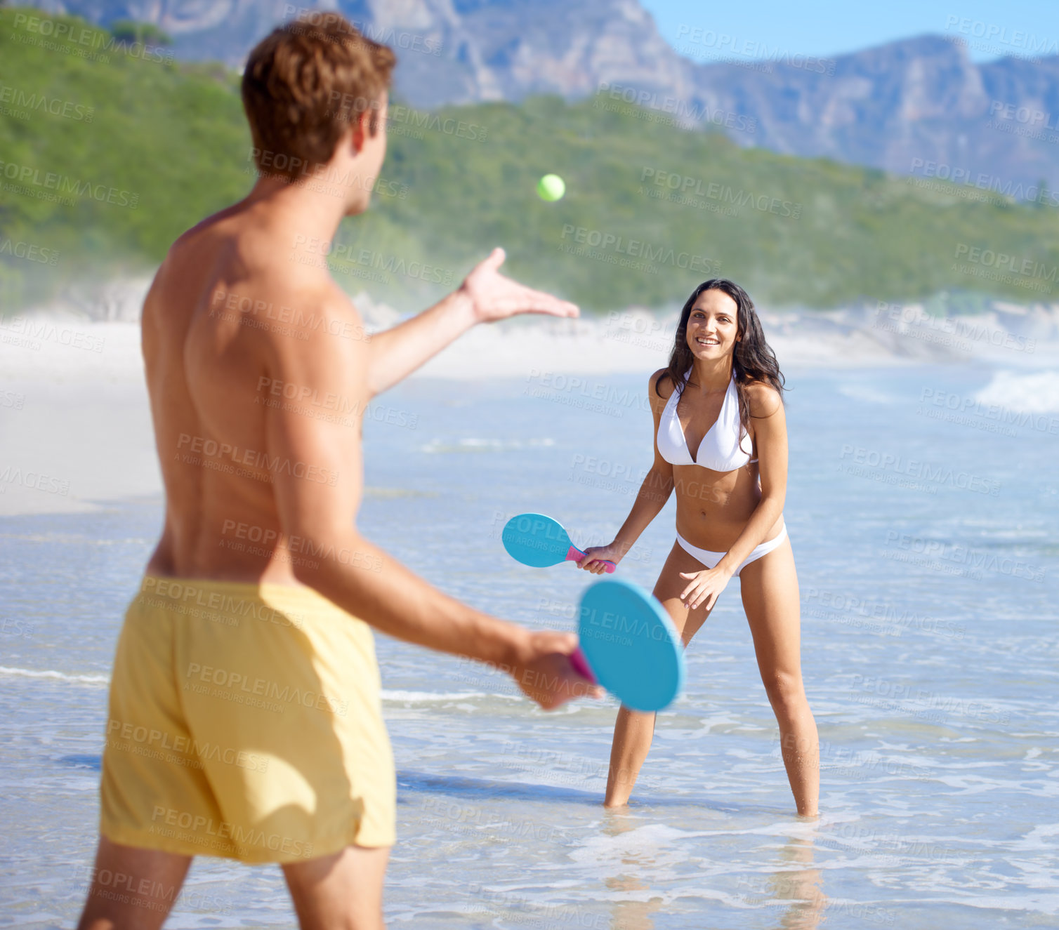 Buy stock photo Travel, paddle ball and couple on beach together, having fun or playing game on holiday in summer. Love, smile or happy with young man and woman in water by sea or ocean for bonding in nature