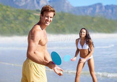 Buy stock photo Portrait, paddle ball and couple on beach together for holiday, vacation or romantic getaway. Smile, sports or love with happy young man and woman dating by ocean or sea for coastal travel in summer