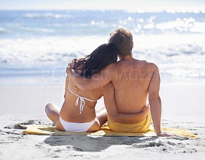 Buy stock photo Relax, hug and couple on beach for holiday adventure together on tropical island with towel from back. Love, man and woman on ocean vacation with embrace, romance and calm nature on travel in Hawaii.