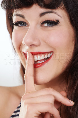 Buy stock photo Portrait, smile and woman with finger for secret, privacy or shush emoji in studio isolated on a white background. Face, happy girl and lips to whisper in silence, quiet or confidential hand gesture