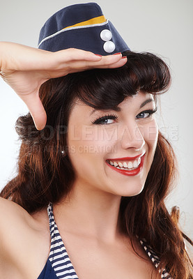 Buy stock photo Travel, portrait and salute of a sailor, woman and model in studio isolated on a white background. Smile, pin up and face of vintage air hostess in hat, makeup and pinup girl in Spain for fashion