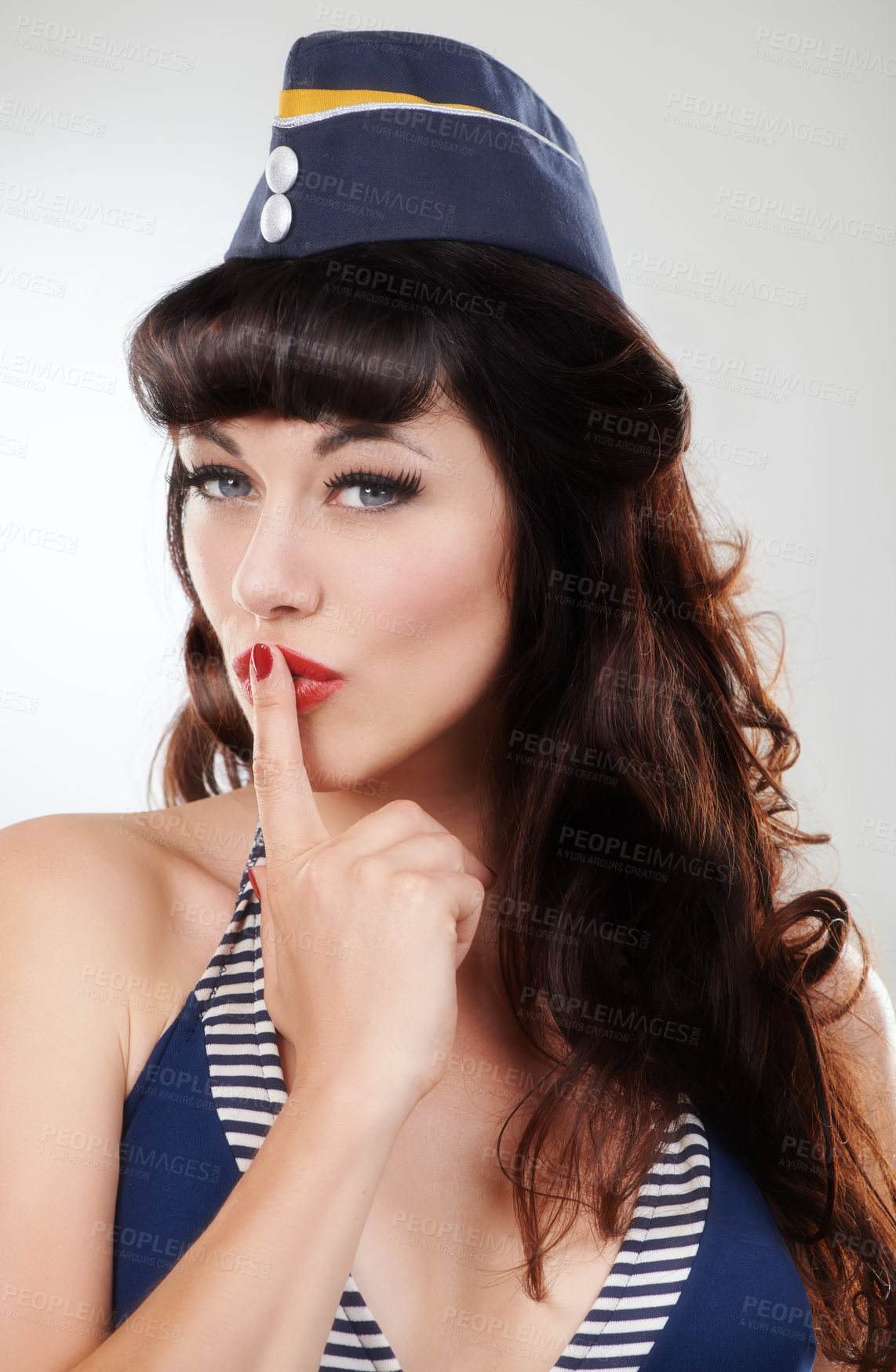Buy stock photo Travel portrait, silence and a sailor woman, model or girl in studio isolated on a white background. Finger on lips, face of vintage person in hat and hand sign for secret, makeup and fashion pin up