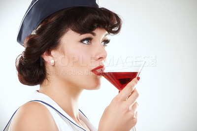 Buy stock photo Glass, stewardess and woman drink alcohol in studio isolated on a white background mockup space. Martini cocktail and an air hostess, vintage pin up girl model or flight attendant travel on journey