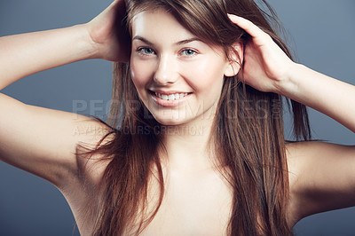 Buy stock photo Beauty, face and smile portrait of a woman in studio with hands in hair care, makeup and cosmetics. Headshot of happy young female model on a grey background for natural glow, skincare or dermatology