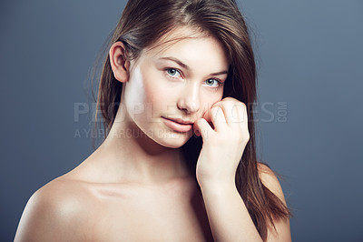 Buy stock photo Natural, face and portrait of a shy woman in studio with a glow, beauty and cosmetics. Headshot of a young female model on a grey background for shine, hair care and facial skincare or dermatology