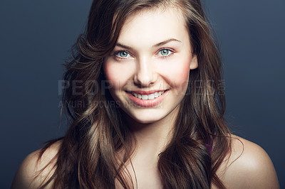 Buy stock photo Beauty, natural and portrait of happy woman in studio with makeup, facial and skincare routine. Health, smile and face of young female model with cosmetic or dermatology treatment by blue background.