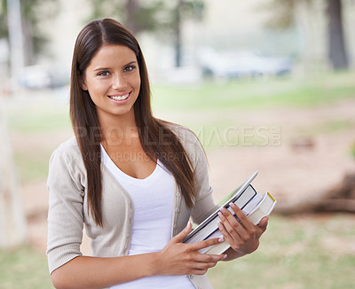 Buy stock photo Student, portrait and happy on campus in park, technology and education with books for studying. University, smile or face for positive in outdoor nature, tablet or learning in commitment in college