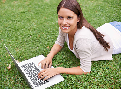 Buy stock photo College student, portrait and woman with laptop in park on campus with research, project and education. University, person and typing on computer outdoor on lawn, grass or garden with happiness
