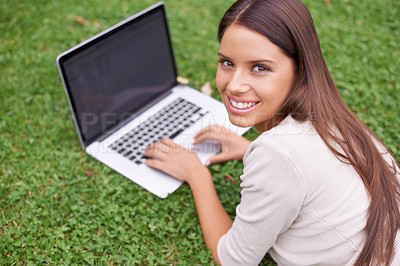 Buy stock photo Woman, portrait and college student with laptop in park on campus with psychology research, project and education. University, person and typing on computer outdoor on grass in garden with happiness