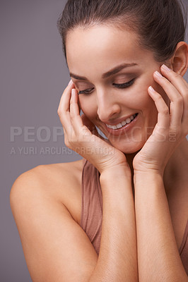 Buy stock photo Woman, hands on face and beauty, cosmetics and skincare with dermatology on purple background. Healthy skin for glow, happy with smile and wellness, self care and grooming for hygiene in studio