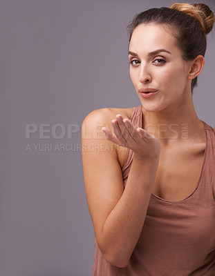 Buy stock photo Portrait of woman, blow kiss or skincare with beauty or cosmetics for healthy glow or results. Isolated, flirting or confident model with natural shine or wellness in studio on purple background 