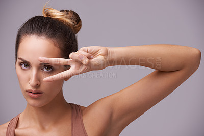 Buy stock photo Portrait, beauty and peace sign with natural woman in studio on gray background for wellness or confidence. Face, skincare or hand gesture and serious young model with v fingers for cosmetics