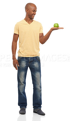 Buy stock photo Studio shot of an attractive African-American man holding an apple and looking at it