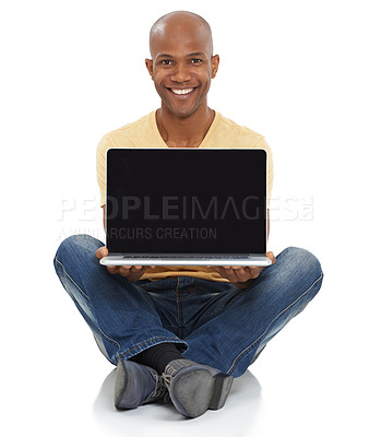 Buy stock photo Studio shot of a smiling African-American man sitting and holding a laptop out in front of him