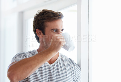 Buy stock photo Man, window and drinking coffee for relaxing at home, hot tea and beverage for contemplating. Morning routine, male person and daydreaming in apartment, cozy and thinking with matcha for inspiration