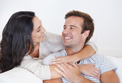 Buy stock photo Happy people, couple hug and love with trust, marriage and relax on sofa at home, healthy relationship and affection. Bonding, loyalty and connection with smile, partner and romance together at house