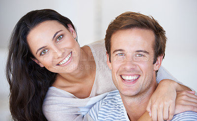 Buy stock photo Portrait, couple and happy for together with love, affection and commitment in marriage with care bonding indoor. Young woman, man and face with happiness in relationship, romantic touch and wellness