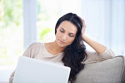 Buy stock photo Woman, reading and laptop on sofa in home, positive and freelancer with typing project in living room. Person, relax and face with computer in online connection, entrepreneur and working in apartment