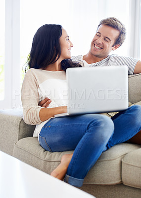 Buy stock photo Couple, laptop and relax together on sofa with love, living room and wellness in marriage for bonding. Woman, man and smile for relationship care on subscription, weekend and streaming video in home