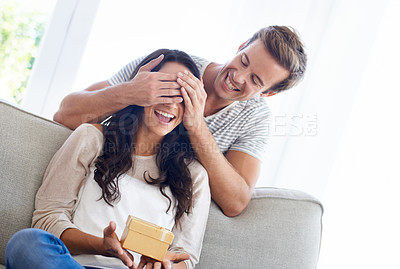 Buy stock photo Surprise, cover eyes and couple in house with gift, love and playful in marriage with anniversary in home. Man, hands and woman face for present in relationship, together and celebrate in living room