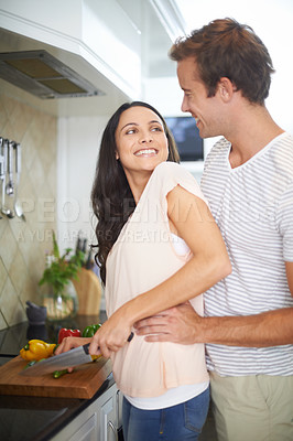 Buy stock photo Couple, hug and cutting vegetables in kitchen, healthy meal and cooking food for eating at home. Happy people, love and bonding together in marriage, nutrition and embracing for support and romance