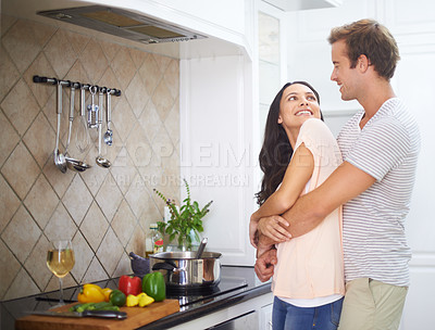 Buy stock photo Couple, hug and cooking together in kitchen, healthy meal and preparing food for eating at home. Happy people, love and bonding together in marriage, nutrition and embracing for support and romance