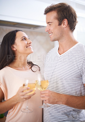 Buy stock photo Couple, love and wine glasses in kitchen, anniversary celebration and commitment to relationship. Happy people, home and bonding together in marriage, alcohol and toasting for support and romance