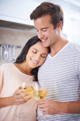 Buy stock photo Couple, hug and wine glasses in kitchen, anniversary celebration and commitment to relationship. Happy people, home and bonding together in marriage, alcohol and toasting for support and romance