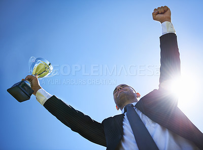 Buy stock photo Low angle view of a businessman holding a cup