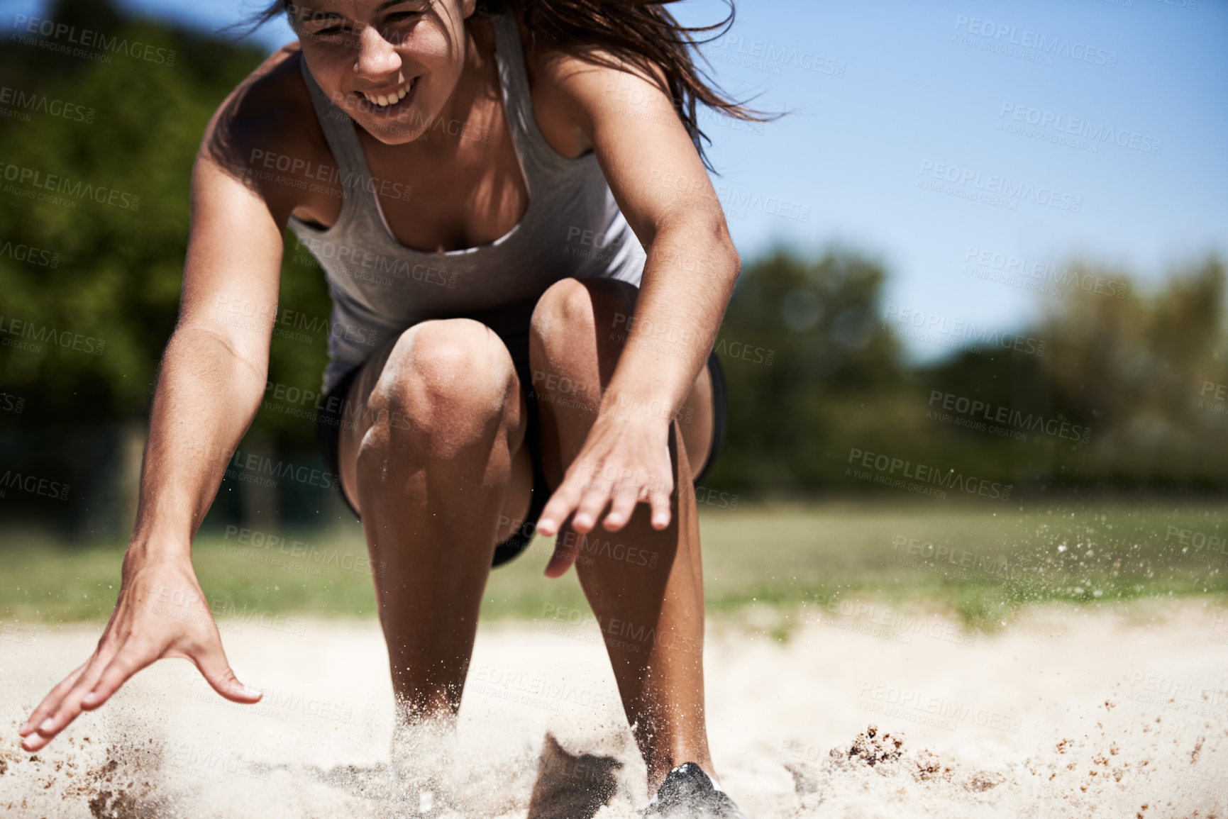Buy stock photo Woman, sand and long jump athlete outdoor training for endurance competition, skill or performance. Female person, face and fitness goal for cardio achievement practice or leap run, wellness or sport